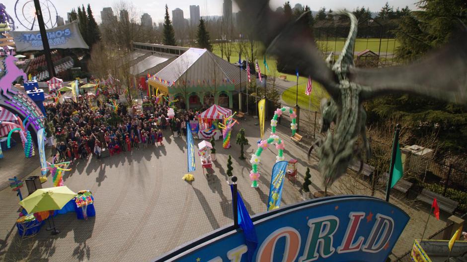 The dragon flies overhead and blocks the exit for the crowd of kids in costume.