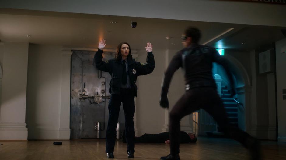 Sue raises her hands as Ralph leaps in front of her to shield her from John Loring's bullets.