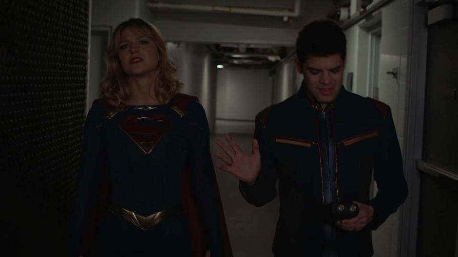 Winn talks to Kara as he looks down at the radiation detector.