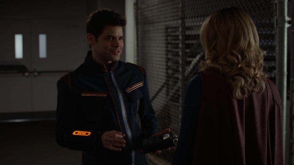 Winn gives Kara some advice on her love life while they search the basement.