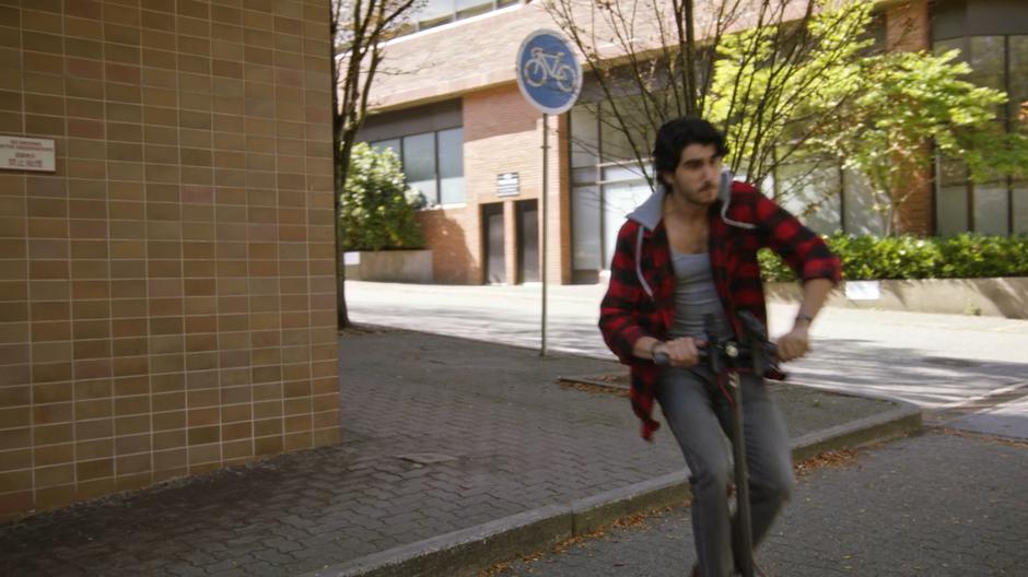 Behrad follows the motorcade and gang around the corner.