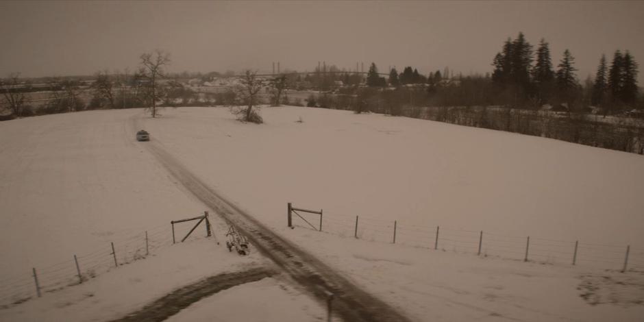 A taxi drives down the path through the snow towards the house.