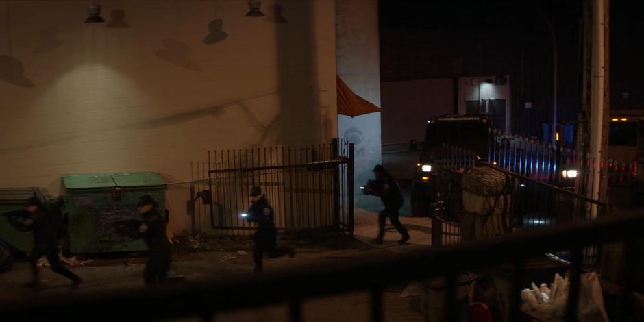 A Crows Security team runs across the parking lot to a building where they got an Alice tip.