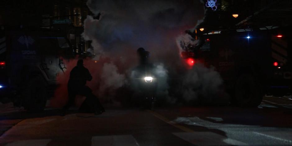 Luke crashes through the checkpoint in a cloud of smoke.