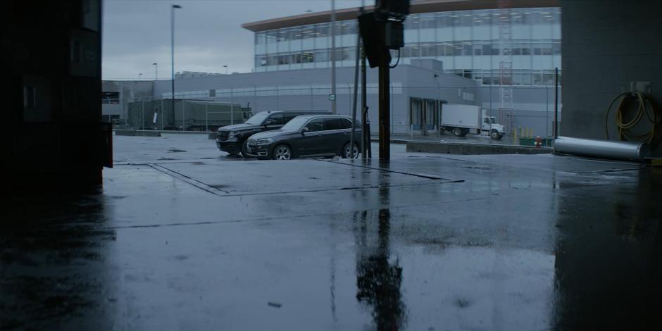 Jacob and Sophie's car sit next to each other in the parking lot visible beyond the loading dock.