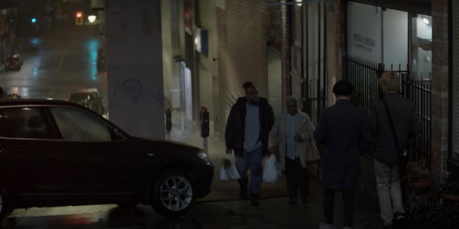 Reggie Harris walks up to his apartment with his mother.