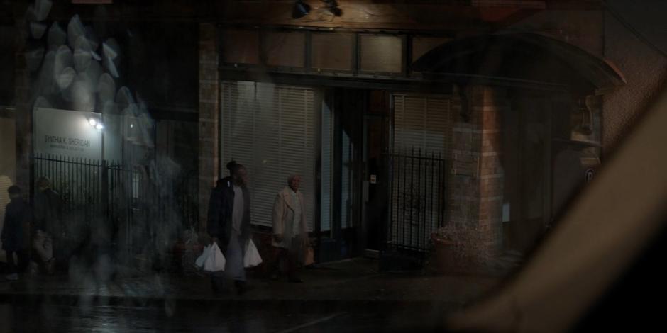 Reggie Harris and his mother are visible through Luke's windshield.