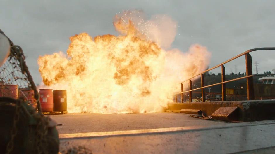 An explosion goes off on the dock engulfing the area where Bruce was just standing.