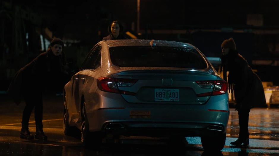 Maggie, Macy, and Mel examine Bruce's abanonded car for any sign of the new danger in the dark.