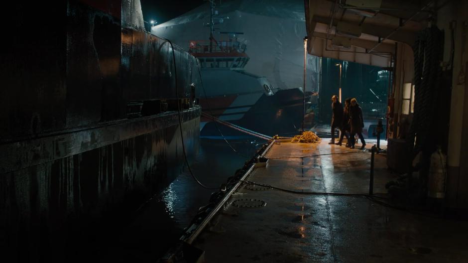 Macy, Mel, and Maggie turn the corner on the dock searching for the abomination at night.