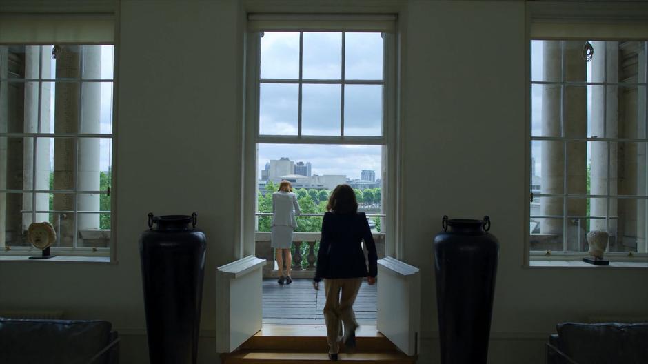 Lind walks out onto the balcony where Myfanwy is leaning against the railing.