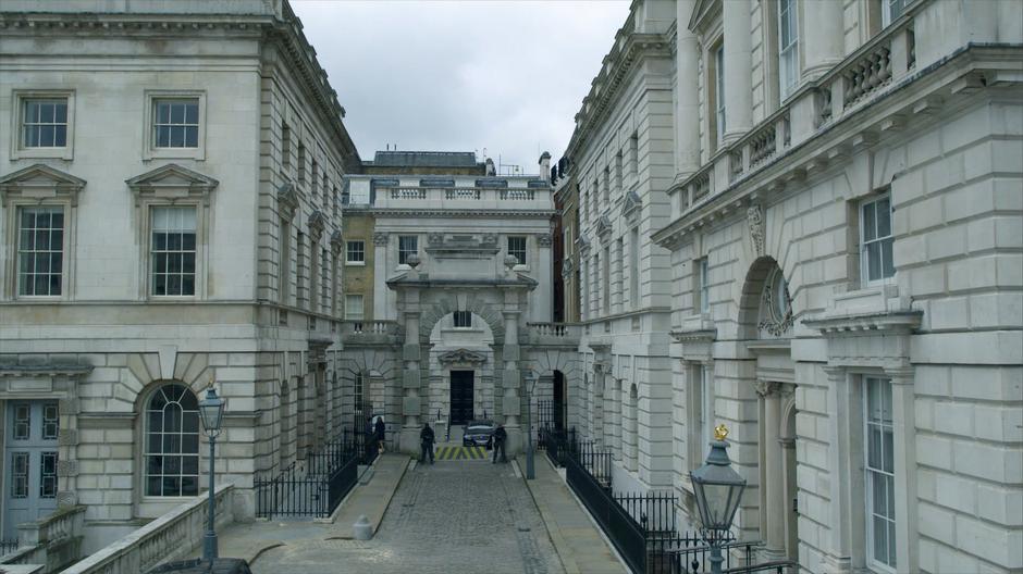 Guards stand at another checkpoint at the edge of the courtyard.