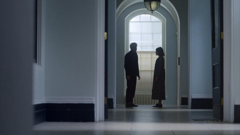 Gestalt and Myfanwy stop in the hallway to talk.