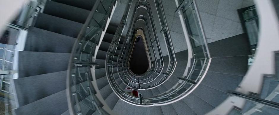 Sabina races down the spiral staircase to the ground floor.