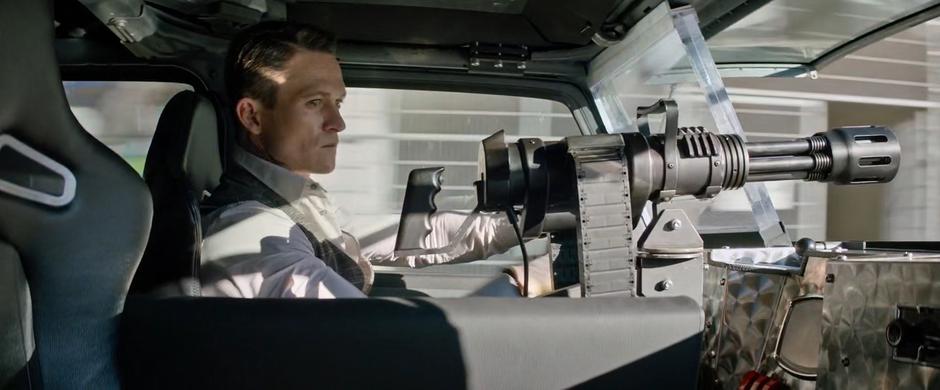 Hodak drives down the street while a mini-gun deploys from the center console next to him.