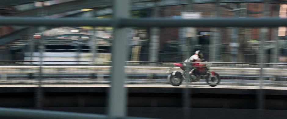 Sabina races after her team on her motorcycle.