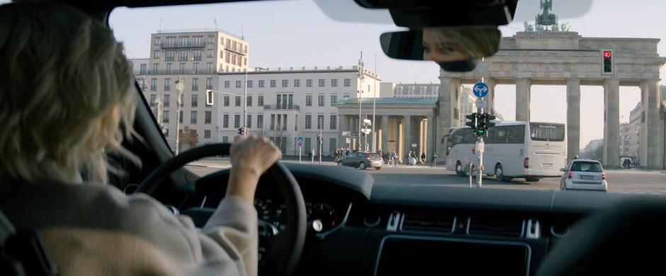 Bosley drives the car up to the intersection in front of Brandenburg Gate.