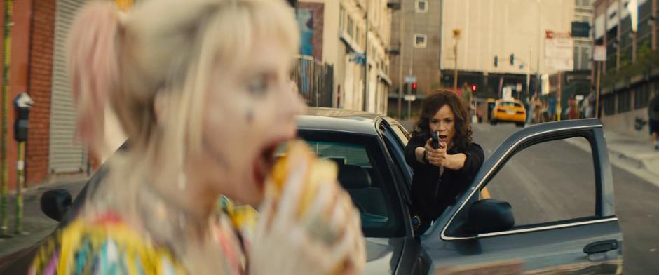 Renee pulls her gun on Harley and demands she stop just as Harley is preparing to take a bite out of her sandwich.