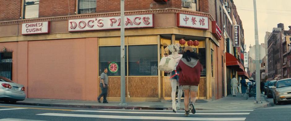 Harley leads Cassandra across the street to the restaurant.