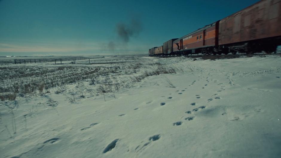 Nicole leaps from the train onto the snow.