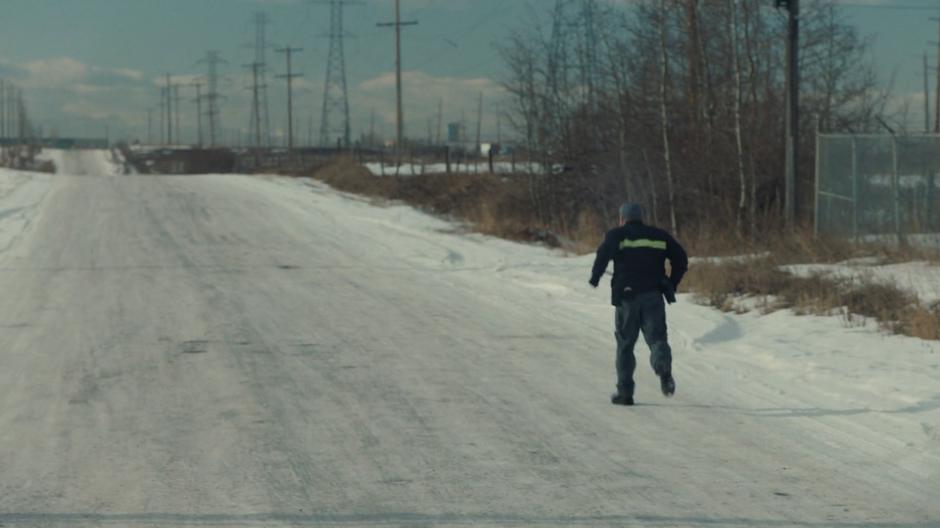 The driver runs off down the snowy road to save his own skin.