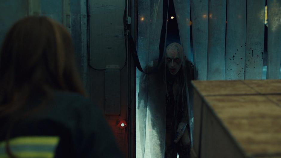 The creature pokes its head through the curtain at the back of the truck to where Wynonna is trapped and terrified.