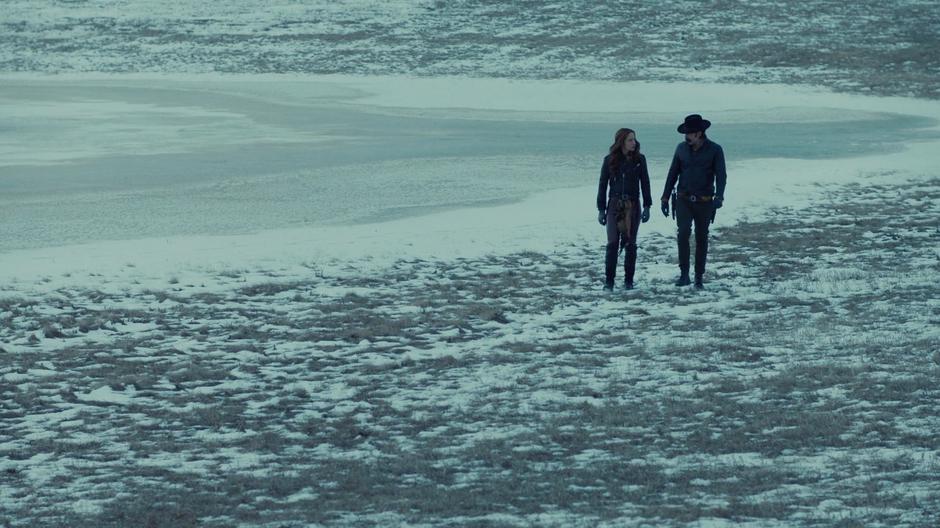 Wynonna and Doc talk while walking across the snowy ground towards the gulch.