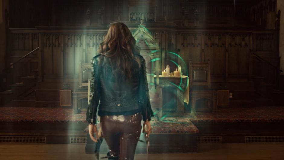 Wynonna walks back through the celtic knot portal to return home.