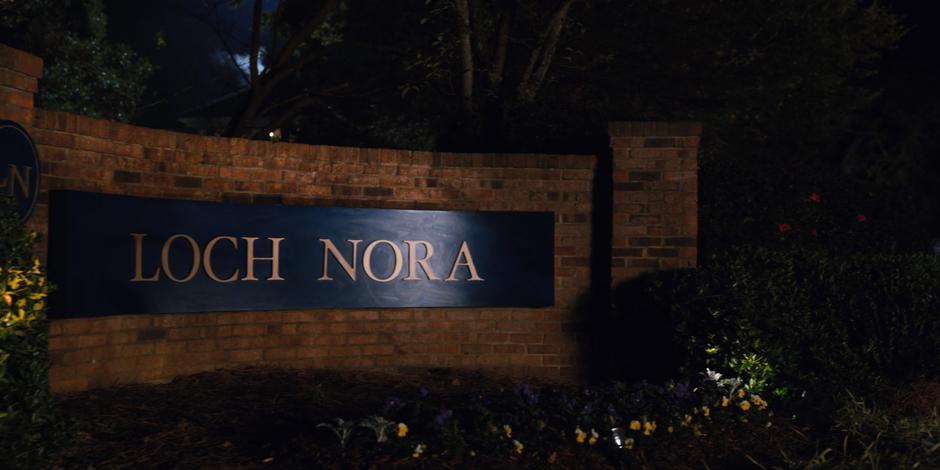 A sign saying Loch Nora sits at the entrance of the neighborhood.