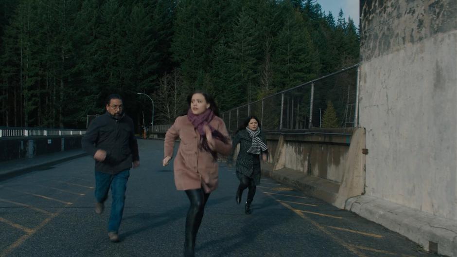 Ray, Maggie, and Mel run across the dam to the stairs leading down.