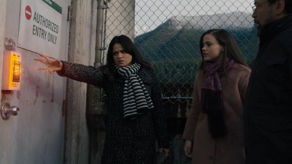 Maggie and Ray watch as Mel uses her powers to fry the lock on the door.