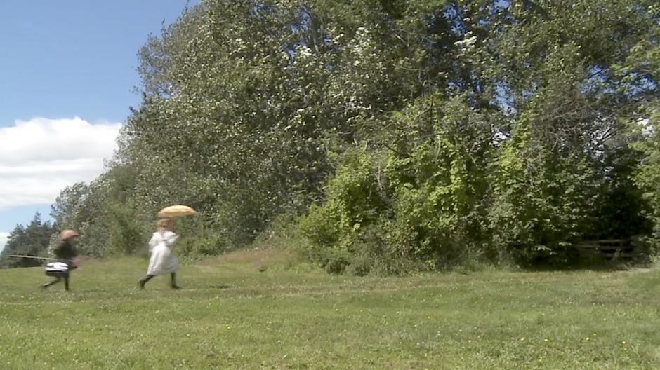 Katie and Sebastian run into the woods near their house.