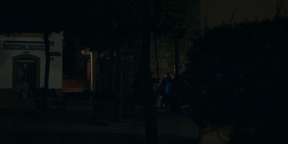 A group of nuns run around to the side entrance of the church in the distance.