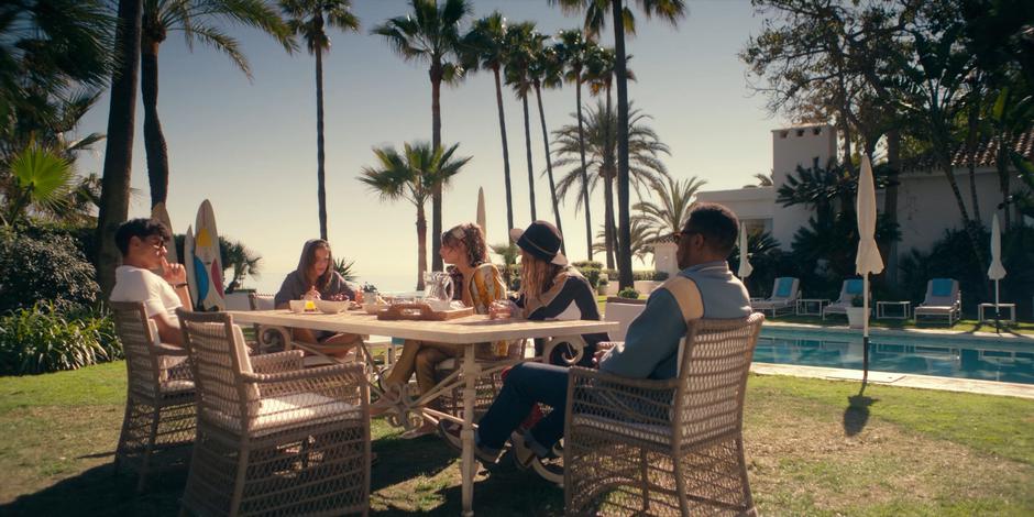 JC, Chanel, Zori, and Randall watch Ava as she sits at the table eating.