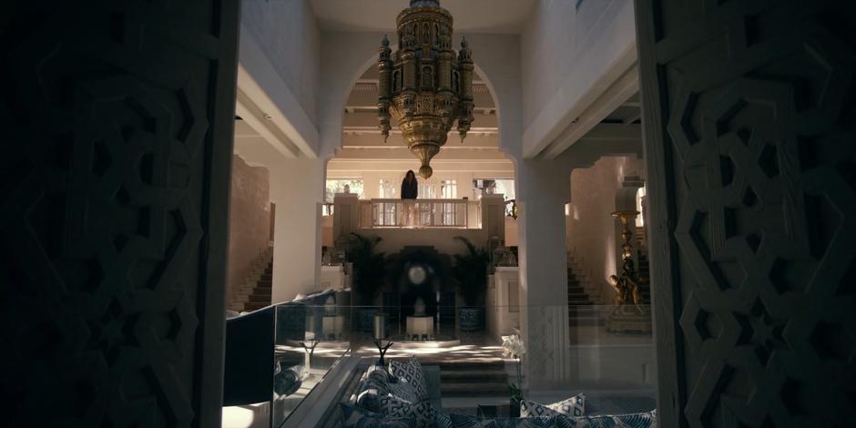 Ava looks around the lavish interior of the villa.