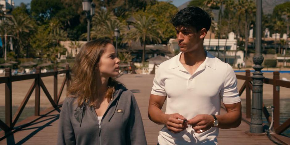 Ava and JC talk while standing at the end of the pier.