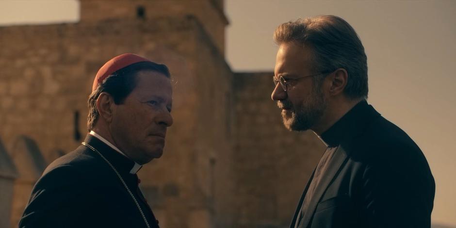 Father Vincent talks to Cardinal Duretti about the halo on the walkway about the training ground.