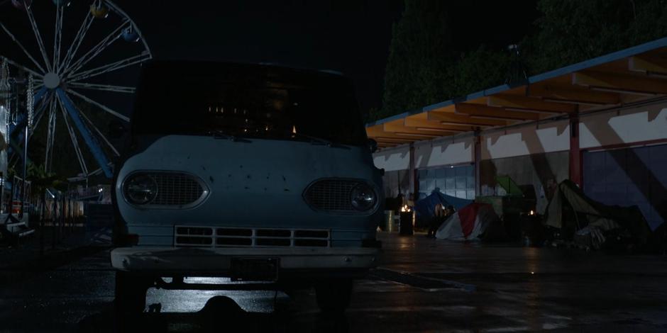 Ryan's van sits parked on the abanonded carnival grounds near a small homeless encampment.