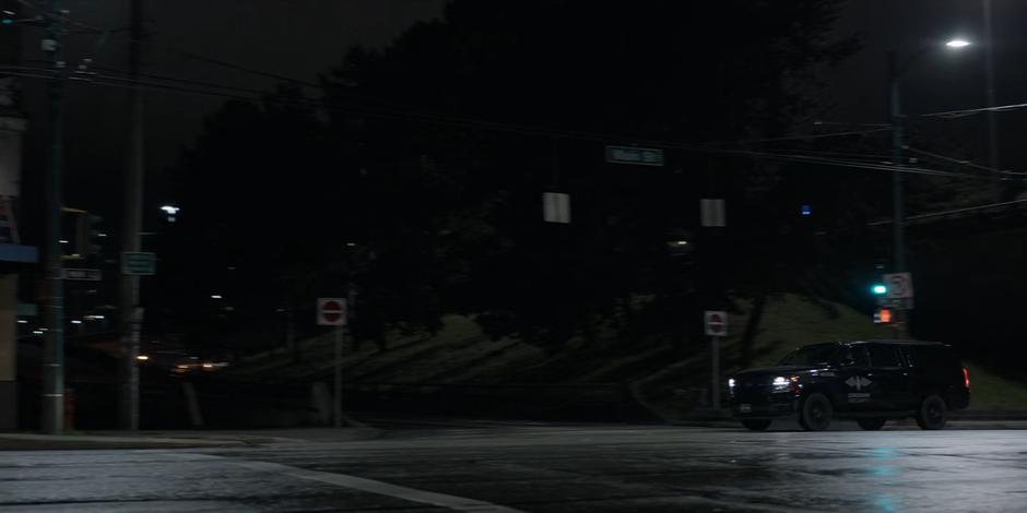 Sophie drives down the street in her Crows vehicle.