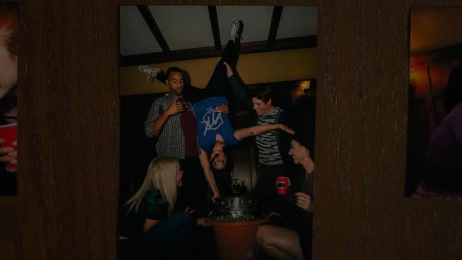 Several college students perform a one-handed keg stand that Maggie pioneered.