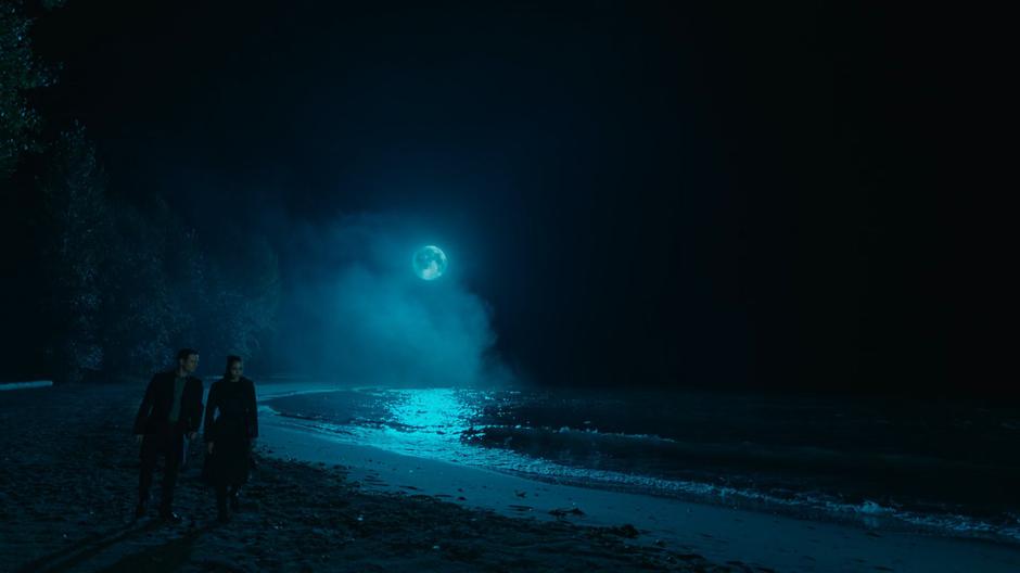 Harry and Macy orb onto a beach at night.