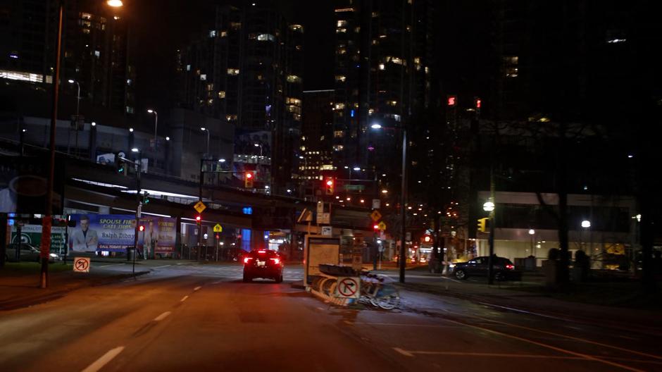 A car stops in front of Joe's at a red light.