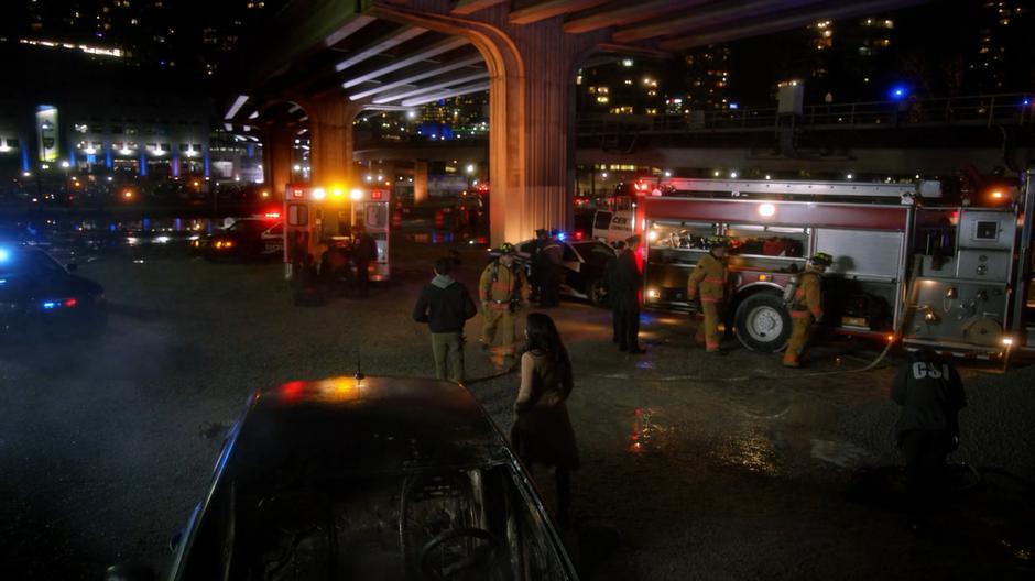 Barry and Iris arrive on the scene of the accident filled with paramedics and firefighters.