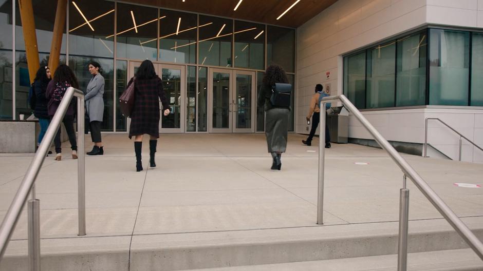 Mel and Maggie walk into the school.