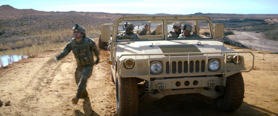 Joaquin jumps out of his humvee as Sam approaches the border.