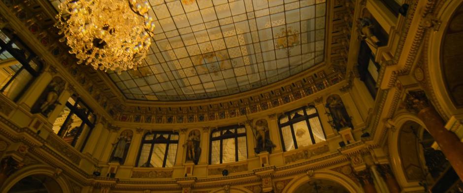 Light shines down from the glass ceiling of the hotel.