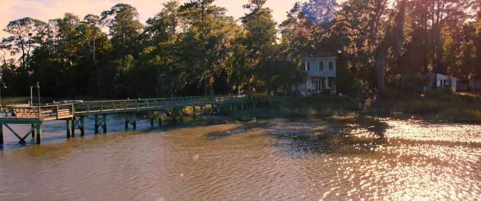 Establishing shot of the house by the water.