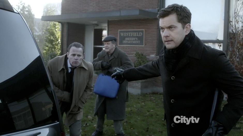 Peter, Walter and Cliff Hayes come out of the sheriff's department.