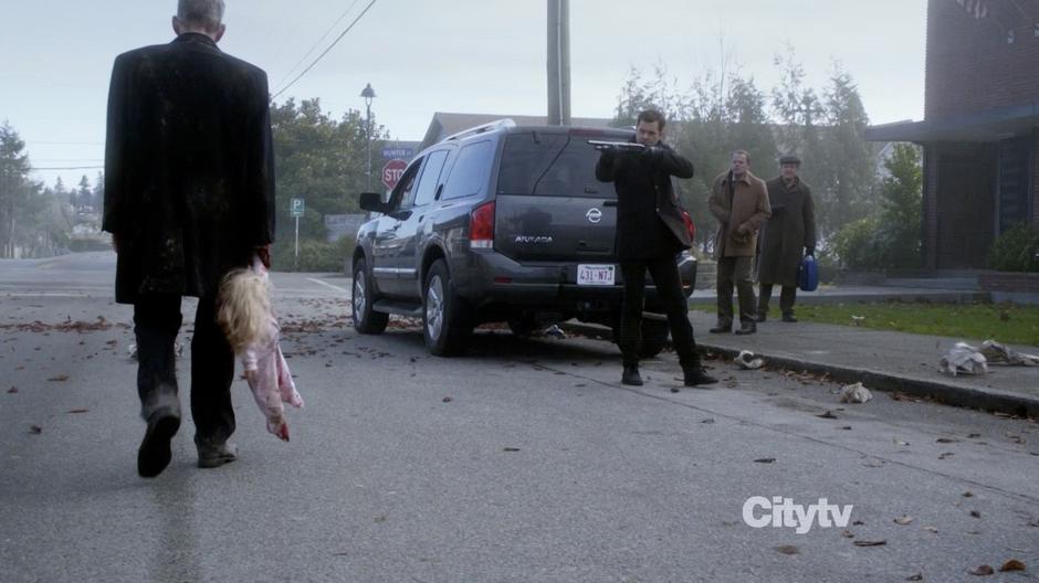 Peter points his gun at an afflicted man while Walter and Cliff Hayes look on.