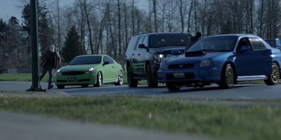 Members of the False Face Society surround the car carrying Angelique.